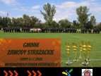 w lewym dolnym rogu na czerwonym tle napis Gminne Zawody Sportowo-Pożarnicze, w prawym dolnym rogu cztery puchary a w tle drużyny OSP stojące na boisku sportowym 